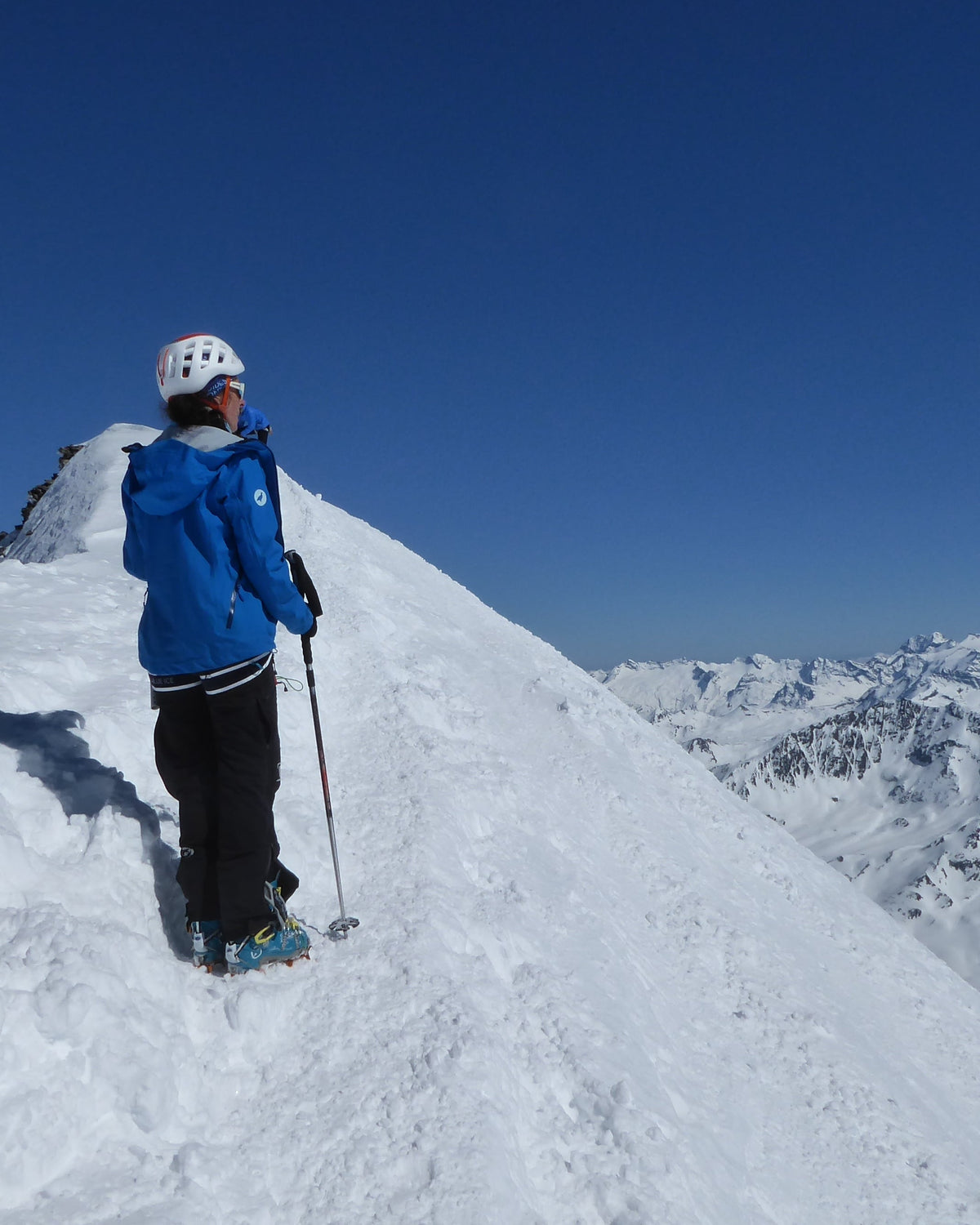 Skieur de randonnée sur une arête sommitale enneigée